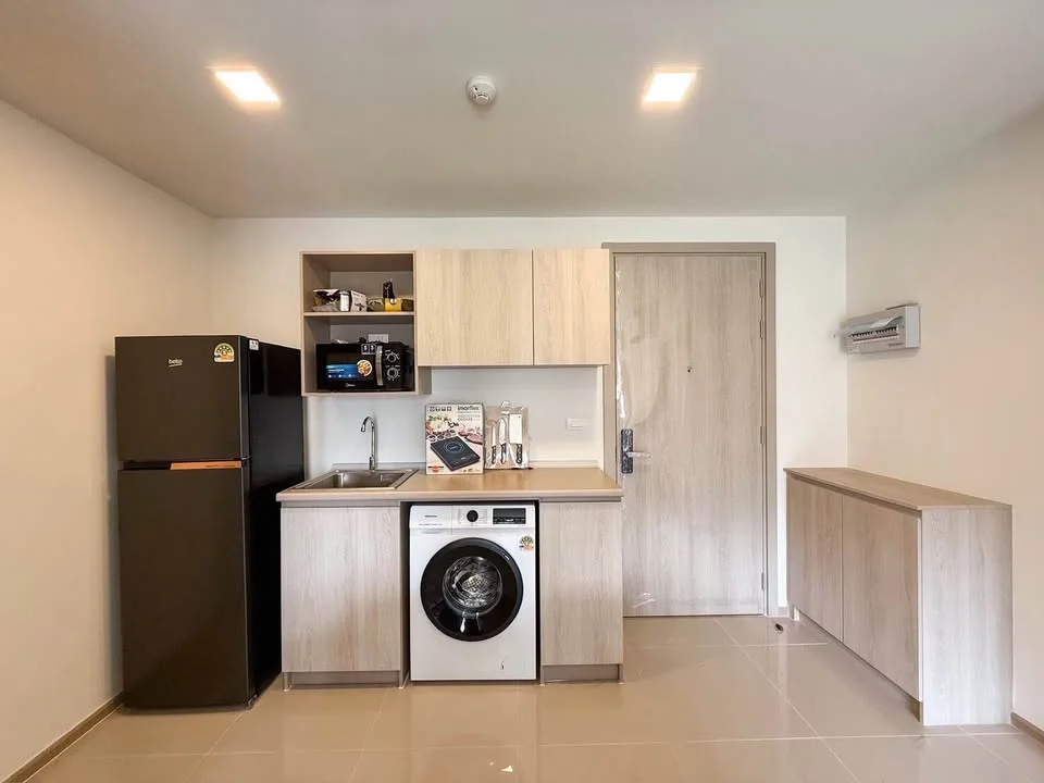 Kitchen interior with washing machine in 2-bedroom apartment at DCondo Reef, Katu